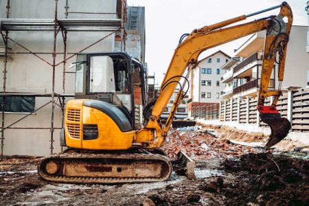 yellow-mini-excavator-digging-fence-foundation-bet-2021-08-27-08-37-11-utc (1)